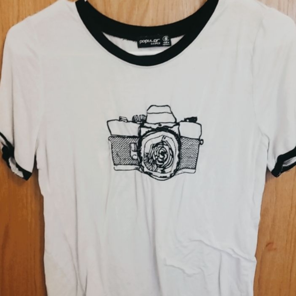 White shirt with black camera sewing design